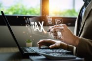 istockphoto-1489003364-612×612 Tax deduction planning concept. Businessman calculating business balance prepare tax reduction. taxes paid by individuals and corporations such as VAT, income tax and property tax.